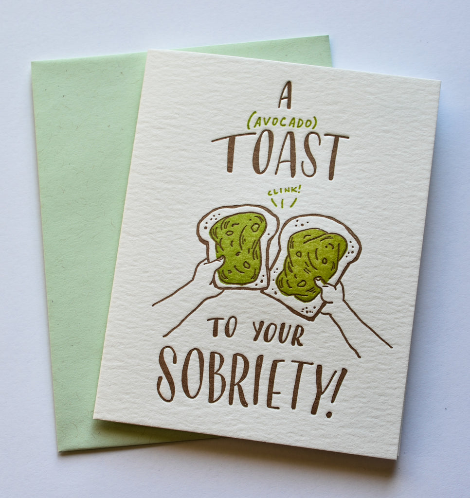 sobriety greeting card with two hand toasting with avocado toast