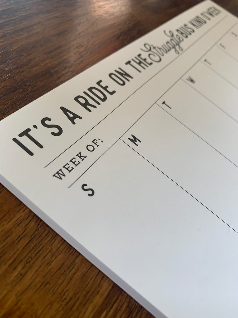 white calendar notepad with black writing