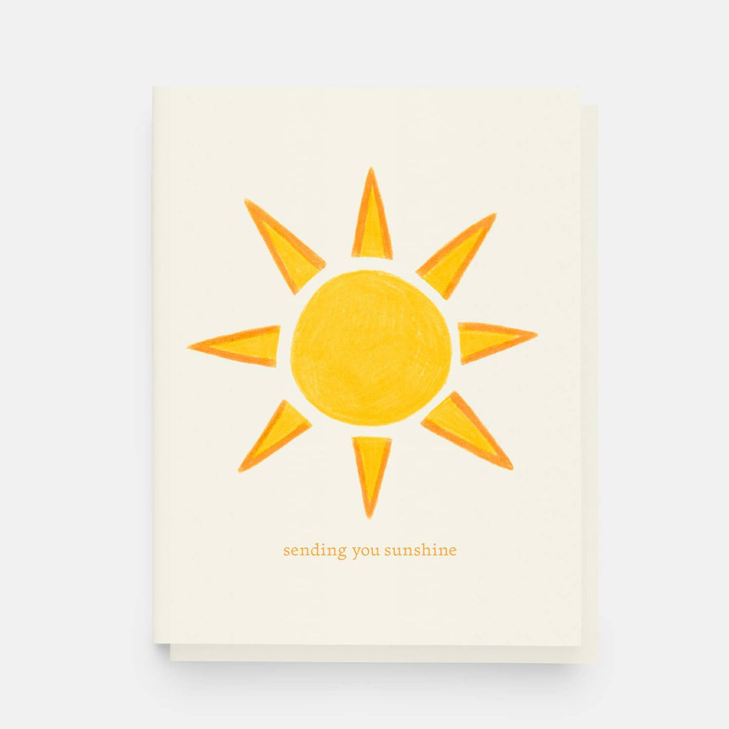 Greeting card with vibrant illustrated sunshine text reads sending you sunshine