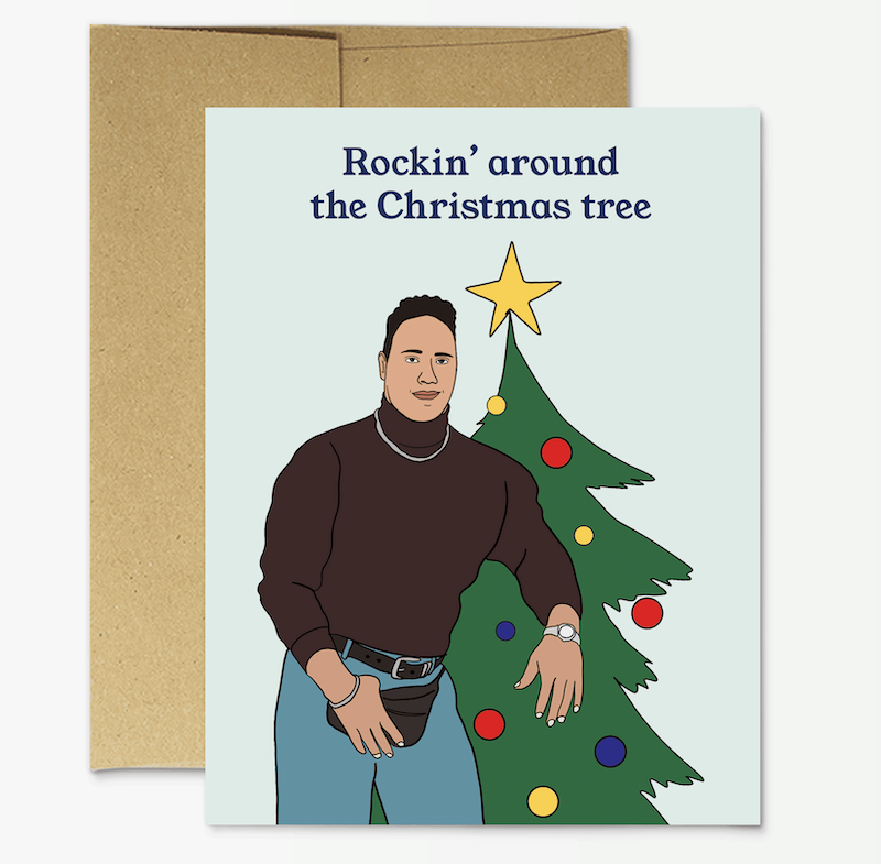 greeting card with light blue background with illustrated image of the rock wearing a fanny pack in front of a Christmas tree